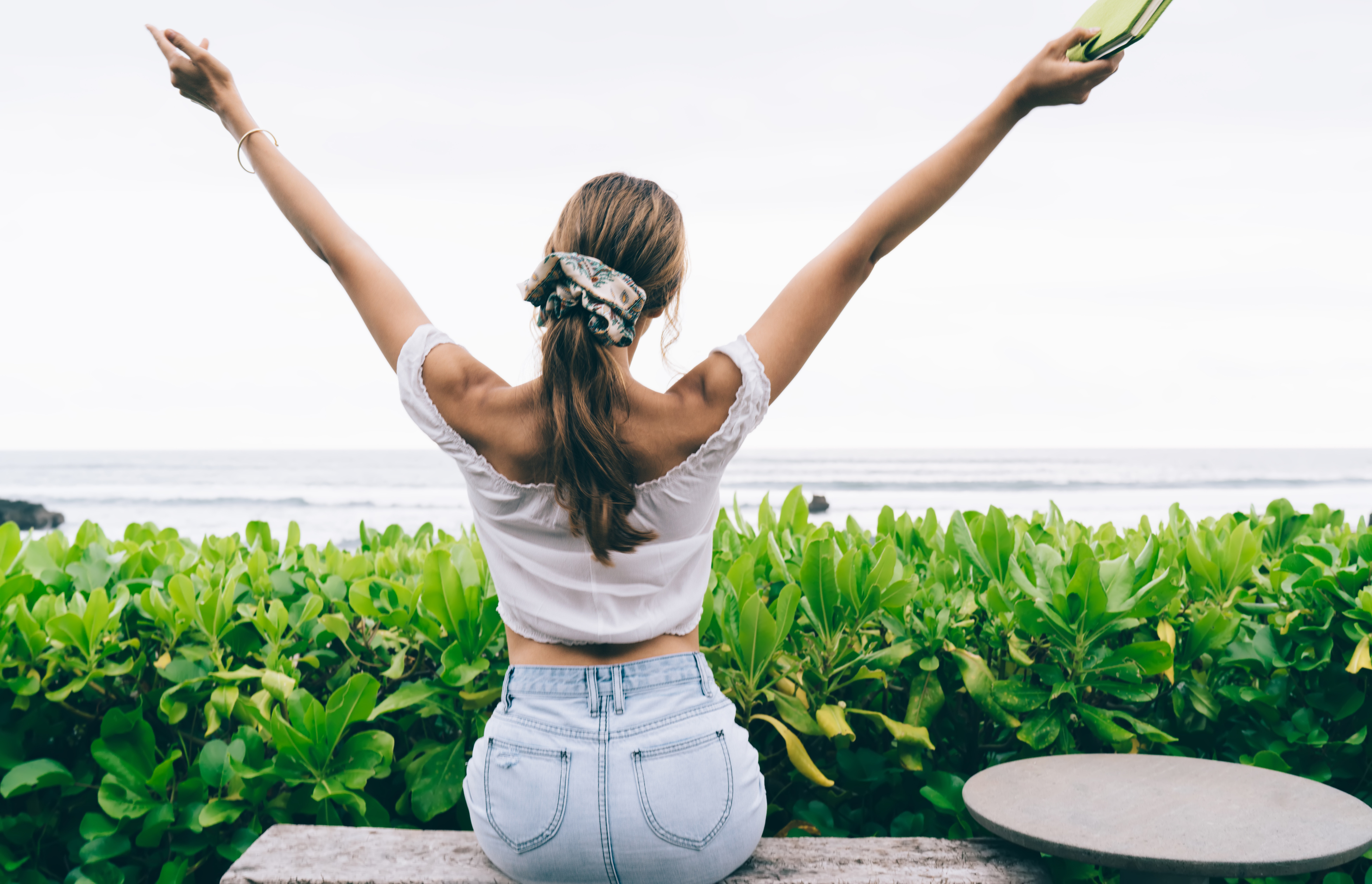 Faceless Woman Relaxing on Terrace near Sea